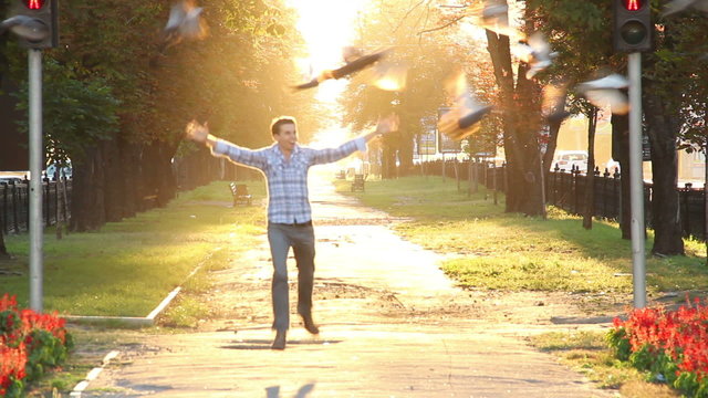 Running man in heaven boulevard scaring birds, enjoying life