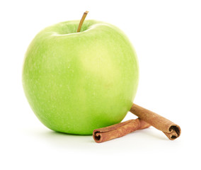 Ripe green apple with cinnamon sticks