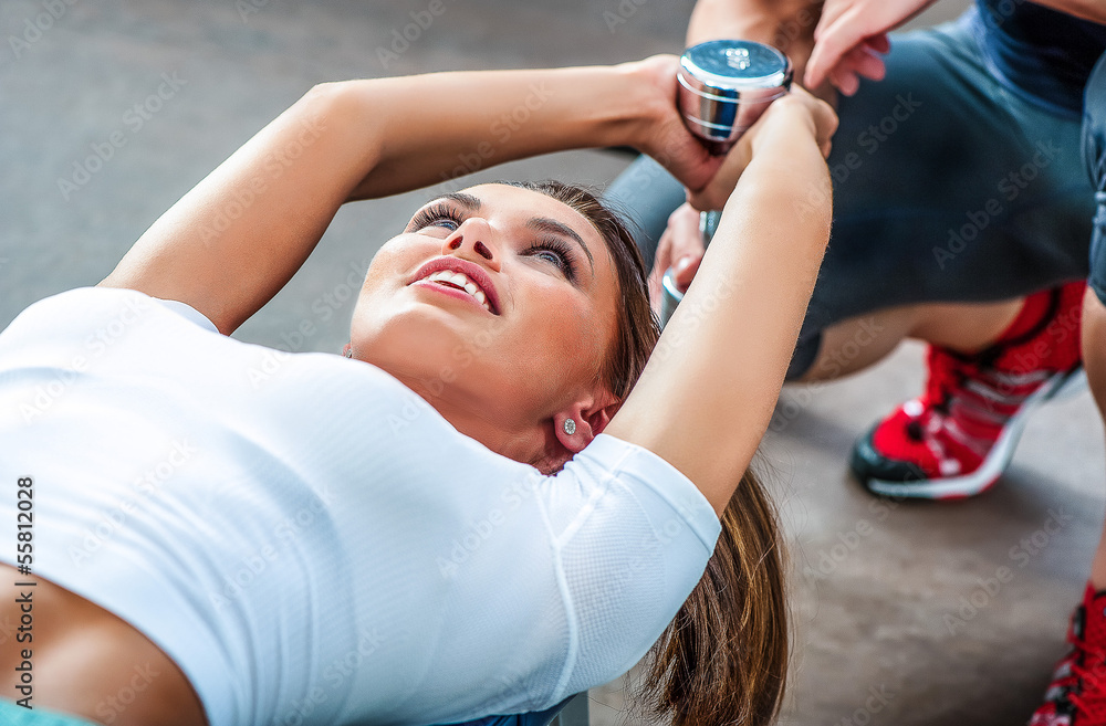 Wall mural young beautiful girl exercise with personal trainer