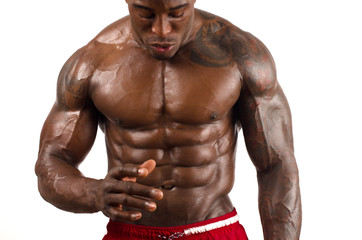 Topless black bodybuilder. Strong man showing perfect muscles