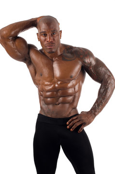 Topless black bodybuilder. Strong man showing perfect muscles