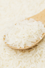 Uncooked white rice on spoon