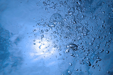 Air bubbles rising to water surface