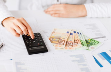 woman hand with calculator and euro money