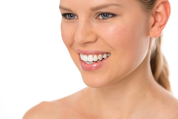 Obraz premium Teeth whitening. Pretty smiling female with healthy teeth.