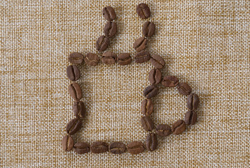 Cup of coffee from coffee beans laid out