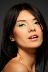 Obraz premium Portrait of a young beautiful brunette woman with make-up