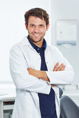 Smiling dentist with arms crossed