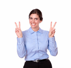 Charming young woman standing with victory sign