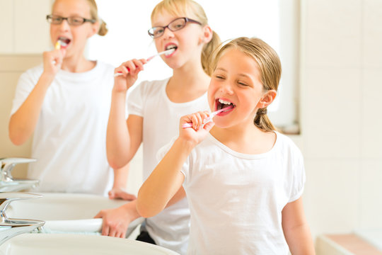 Mädchen beim Zähne putzen im Bad