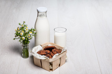 milk bottle and glass on wooden background