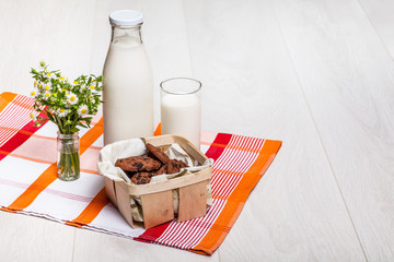 milk bottle and glass on wooden background