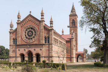India Kanpur: All Souls Church in its park with tower and rose-w