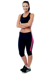 Confident young fit woman, arms crossed