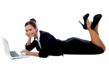 Relaxed corporate woman working on laptop