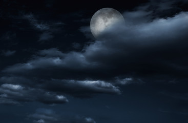 Naklejka na ściany i meble Full moon in night sky with clouds.