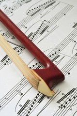 Violin bow tip on sheet music background