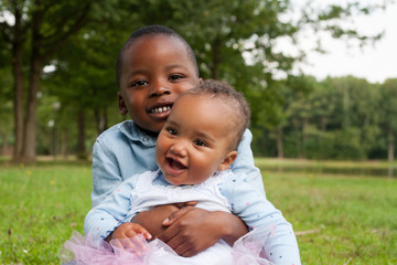 Naklejka na ściany i meble Smiling african boy and his sister
