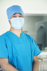 Fototapeta na wymiar Portrait of young surgeon wearing surgical mask in the operating room