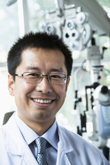 Portrait of smiling optometrist in his clinic
