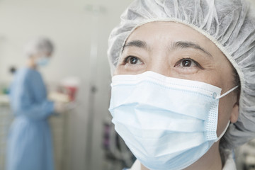 Portrait of surgeon with surgical mask and surgical cap in the operating room 