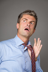 Tired businessman pulling his collar