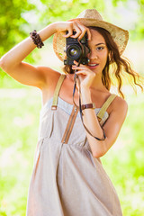 happy young girl with camera outdoors