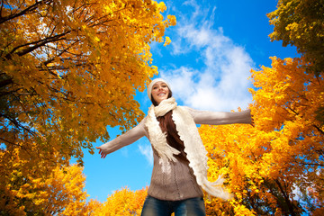 happy woman on a autumn sky background
