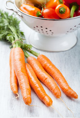 fresh carrot and vegetables in colander