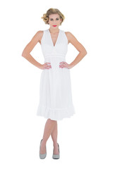 Lovely fashion blonde model posing with hands on the hips