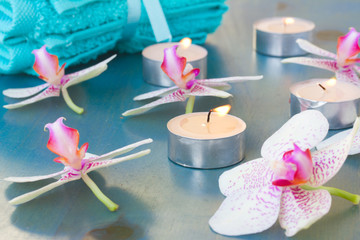 burning candles and orchid flowers