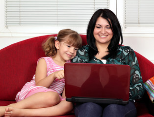 little girl and woman with laptop