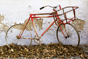 Decorative old bicycle against an old peeling wall