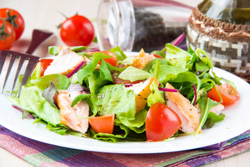 Delicious fresh salad with salmon, lettuce, cherry tomatoes