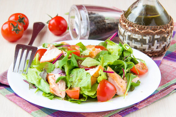 Delicious fresh salad with salmon, lettuce, cherry tomatoes and