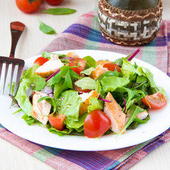 Delicious fresh salad with salmon, lettuce, cherry tomatoes and