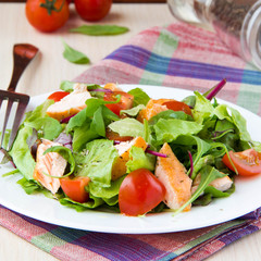Delicious fresh salad with salmon, lettuce, cherry tomatoes and