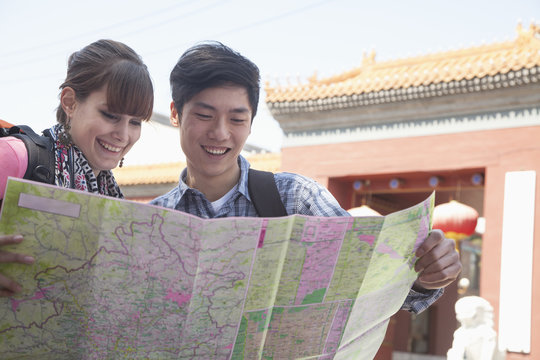 Young Couple Looking At Map. 