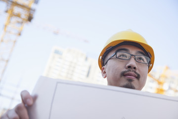 Architect looking at blueprint