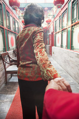 Fototapeta premium Senior couple holding hands, rear view