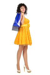 brunette in a yellow dress with shopping bags
