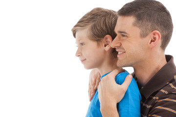 Fototapeta premium Father and son. Cheerful father and son looking away while stand