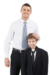 Father and son. Cheerful father in formalwear and son standing c