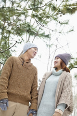 Young couple looking at each other in a park in winter