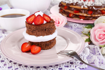 Chocolate cake with strawberry on wooden table close-up