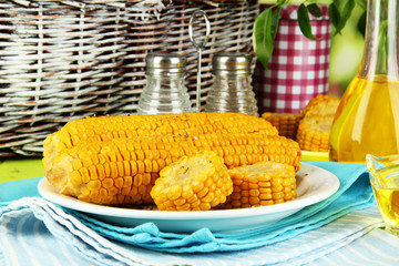 Flavored boiled corn on  plate on wooden table close-up