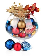 Glass bowl filled with christmas decorations, isolated on white