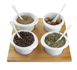 Assortment of spices in  white  bowls,