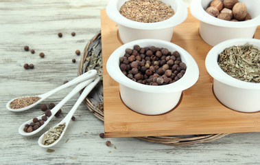 Assortment of spices in  white spoons and bowls,