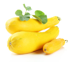 Raw yellow zucchini with leaves, isolated on white